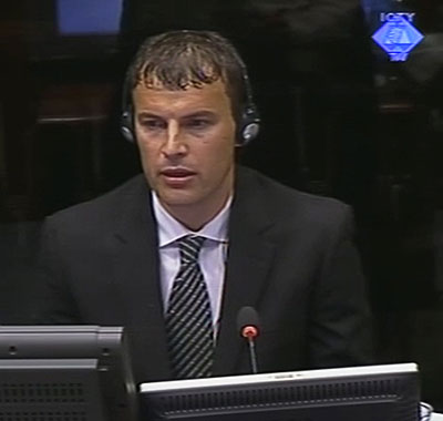 Elvedin Pasic giving testimony in the court room in The Hague, Netherlands.