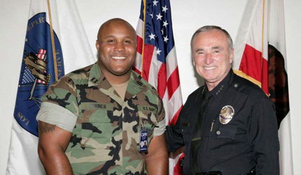 Christopher Dorner, left, with then-LAPD Chief William J. Bratton, in a photo from the August 2006 issue of the Beat police newsletter.
