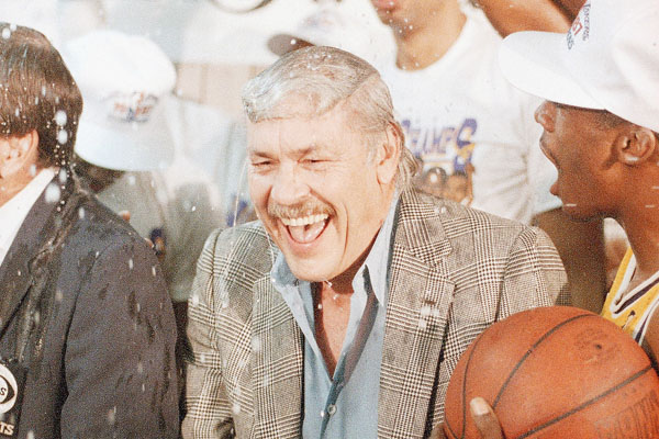 Los Angeles Lakers owner Jerry Buss gets doused with champagne by members of his team.