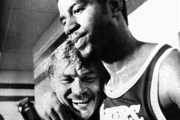 Magic Johnson hugs Lakers owner Jerry Buss in the locker room after the team won the 1980 NBA championship.