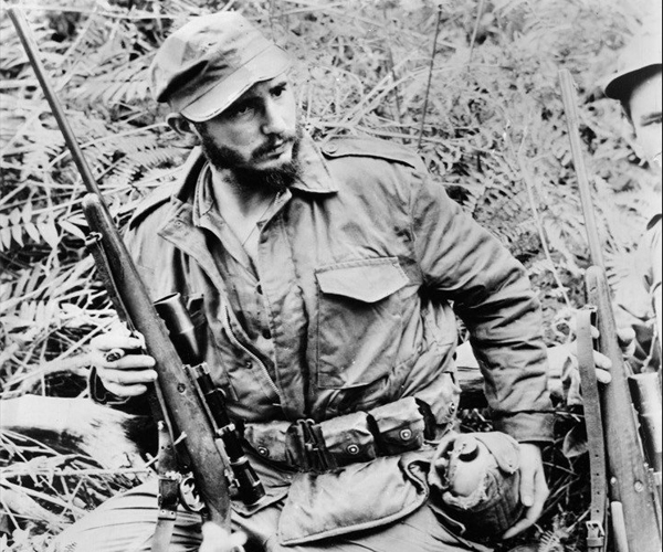 Fidel Castro stands with his double-triggered rifle in this undated photo, received by The Times in 1958.