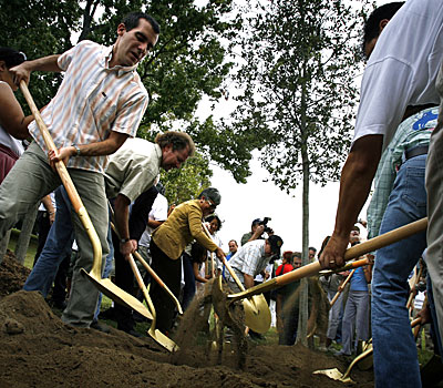 Los Angeles Council member Eric Garcetti (left) joins others in planting the symbolic first tree at Hazard Park in Boyle Heights.
