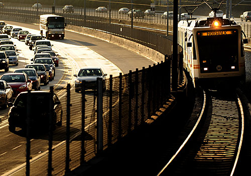 A Green Line train heads eastbound as it passes traffic on the 105 freeway near the Hawthorne Boulevard stop. The U.S. Senate's approval of a transportation bill could help accelerate transportation projects including an extension of the Green Line to LAX. 