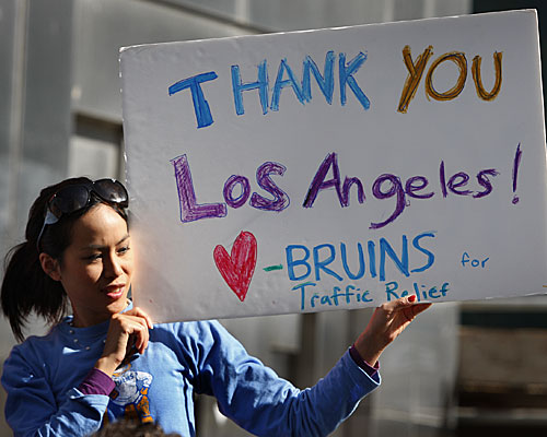 UCLA graduate student and Bruins for Traffic Relief club member Sirinya Tritipeskul holds a sign at a news conference noting voter approval of Measure R.