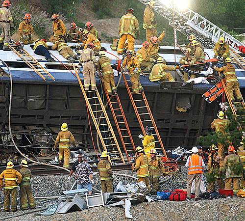Fire and emergency personnel work to free passengers who were trapped when a Metrolink commuter train collided head-on with a Union Pacific freight train in Chatsworth.