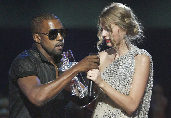 Rapper Kanye West takes the microphone from singer Taylor Swift as she accepts the best female video award during the 2009 MTV Video Music Awards.