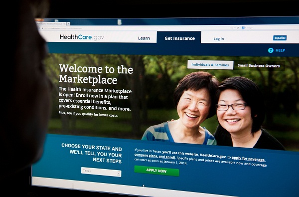 A woman looks at the HealthCare.gov insurance exchange site.