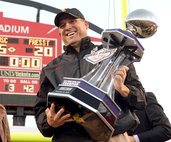 USC Interim Coach Clay Helton holds the championship trophy after defeating Fresno State, 45-20, in the Royal Purple Las Vegas Bowl.