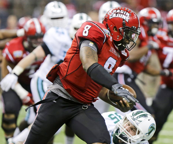Louisiana-Lafayette quarterback Terrance Broadway gets around Tulane safety Sam Scofield during the Ragin' Cajuns' victory over the Green Wave, 24-21, in the New Orleans Bowl.
