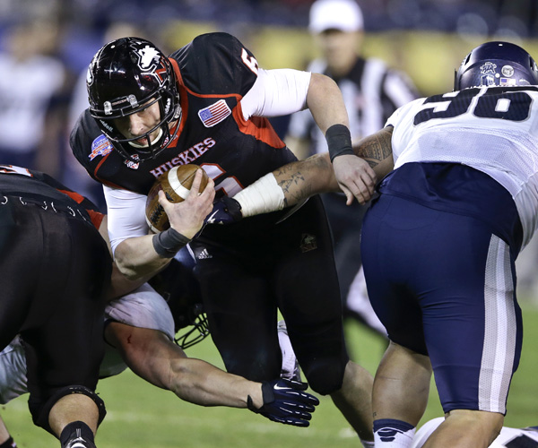 Northern Illinois quarterback Jordan Lynch plows through the Utah State defense for a first down. The Aggies held Lynch and Co. to two touchdowns in a 21-14 victory.