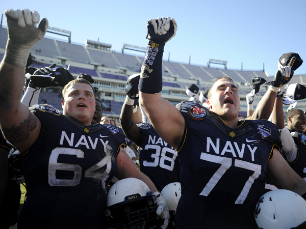 Navy players celebrate their 24-6 victory over Middle Tennessee State in the Armed Forces Bowl.