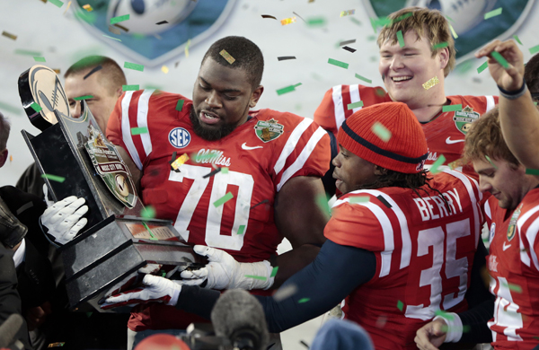 Mississippi offensive lineman Emmanuel McCray, left, and defensive back Ontario Berry celebrate their 25-17 victory over Georgia Tech in the Music City Bowl in Nashville, Tenn.