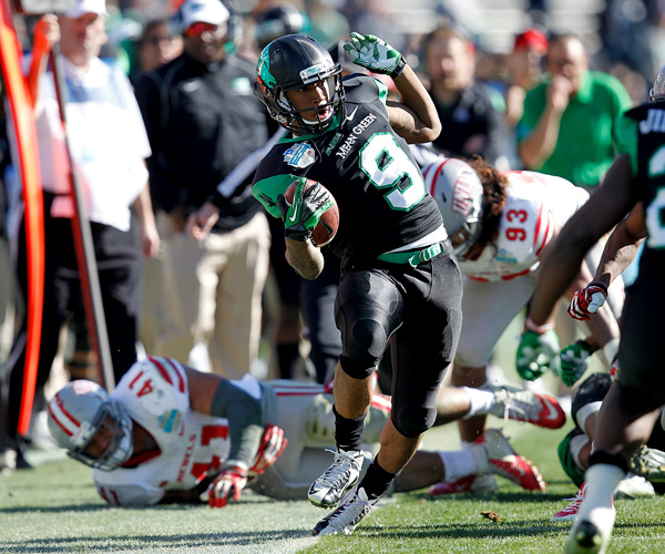 North Texas receiver Carlos Harris can't avoid stepping out of bounds after a reception against UNLV in the first half of the Heart of Dallas Bowl. Derek Thompson threw for 256 yards and two touchdowns while Brelan Chancellor had two touchdown runs in the fourth quarter for the Mean Green.