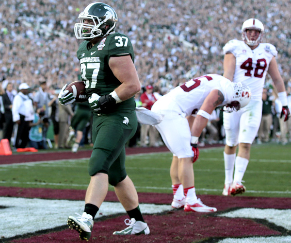 Michigan State fullback Trevon Pendleton celebrates after scoring on a two-yard touchdown pass against Stanford late in the first half of the Rose Bowl. The Spartans fell behind by 10 points early in the game before rallying in the second half for the victory.