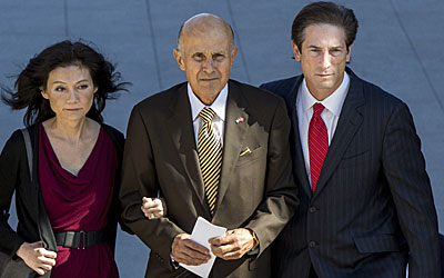 Lee Baca, center, his wife Carol, and his attorney Nathan Hochman, leave the Los Angeles Federal Courthouse.