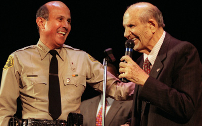 Baca laughs with former L.A. County Sheriff Peter Pitchess shortly after the swearing in ceremony in Pasadena.