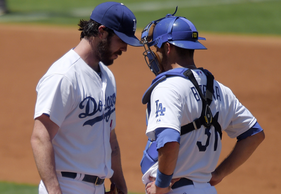 Dodgers starter Dan Haren, left, talks with catcher Drew Butera during the third inning of the team's 7-2 loss.
