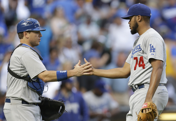 Dodgers catcher A.J. Ellis, left, and closer Kenley Jansen celebrate the team's 5-1 win over the Milwaukee Brewers.