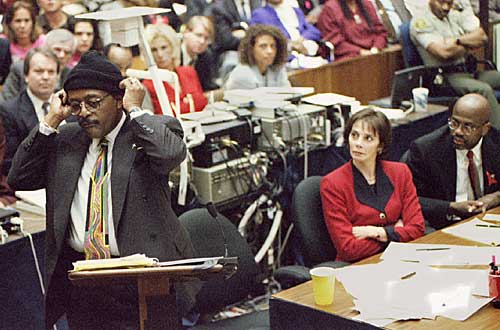 Defense attorney Johnnie Cochran Jr. puts on a knit ski cap as he addresses jurors during closing arguments. 