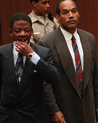 O.J. Simpson stands with attorney Carl Douglas as the jury enters the courtroom to announce that it had reached a verdict in the double-murder trial. 