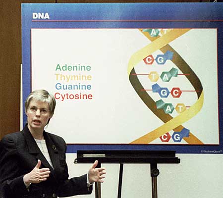 Cellmark Diagnostics lab director Robin Cotton refers to a chart as she explains the concept of DNA to the jury.