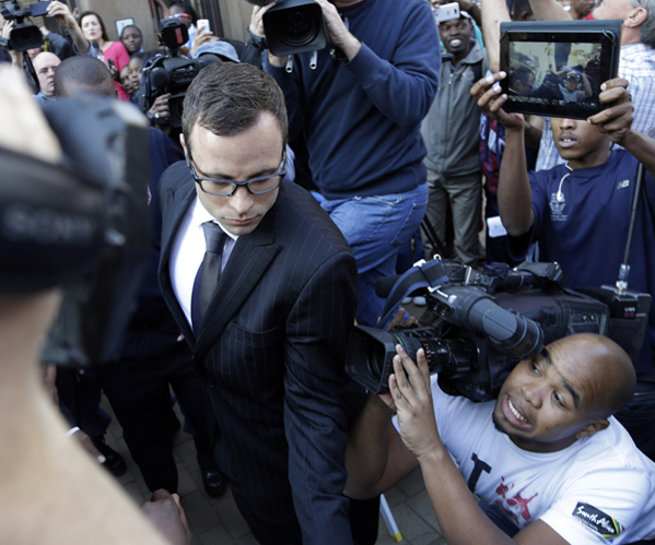 Pistorius is surrounded by reporters and onlookers as he leaves the high court in Pretoria.