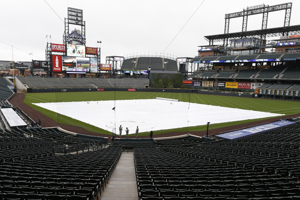A tarp covers the infield at Coors Field following the cancellation of the Dodgers-Rockies game on May 9, 2015.