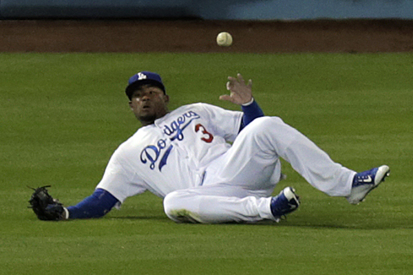 Dodgers left fielder Carl Crawford can't make a sliding catch on a run-scoring triple by Padres left fielder Justin Upton during the first inning.