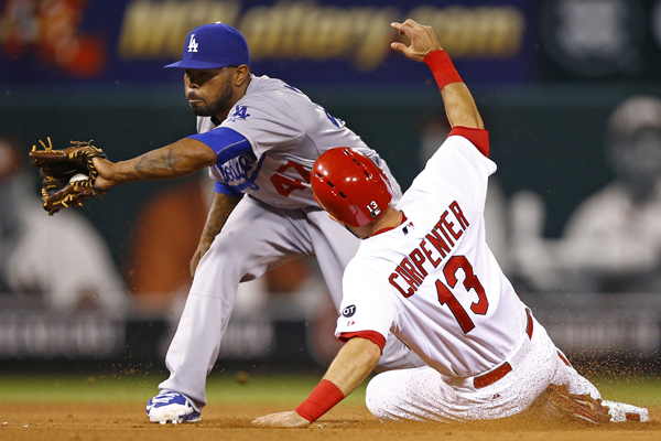 Cardinals' Matt Carpenter steals second base, beating the tag of Dodgers second baseman Howie Kendrick during the fifth inning of the Dodgers' 3-0 loss.