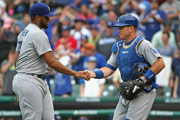 Dodgers closer Kenley Jansen, left, and catcher A.J. Ellis shake hands after a 4-0 victory over the Chicago Cubs.