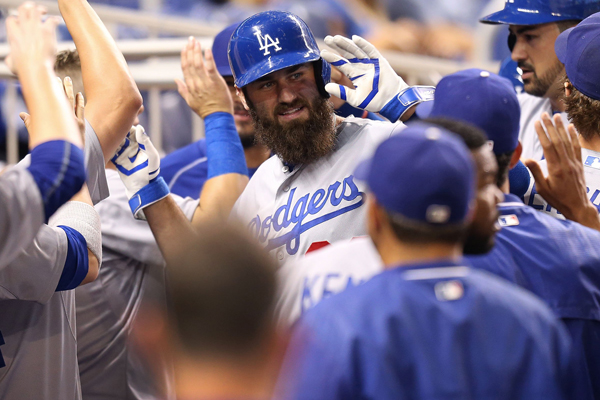 Dodgers outfielder Scott Van Slyke celebrates in the dugout after hitting a two-run home run during the second inning of a 7-1 win over the Miami Marlins.