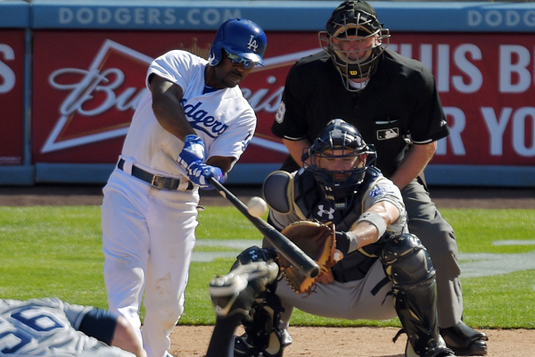 Dodgers shortstop Jimmy Rollins hits a three-run home run off San Diego Padres reliever Shawn Kelley during the eighth inning of the Dodgers' opening day win.