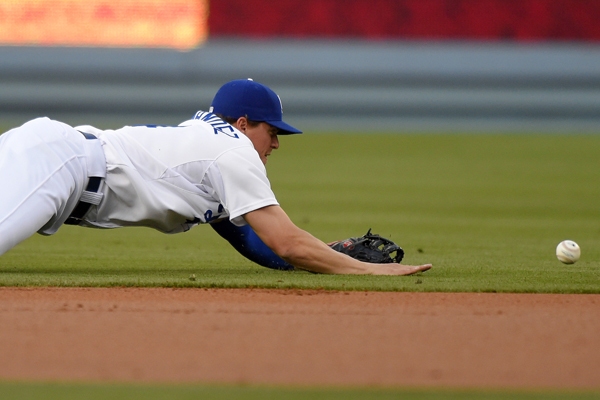 Dodgers shortstop Enrique Hernandez can't stop a single by St. Louis' Jhonny Peralta during the first inning of the Dodgers' loss.