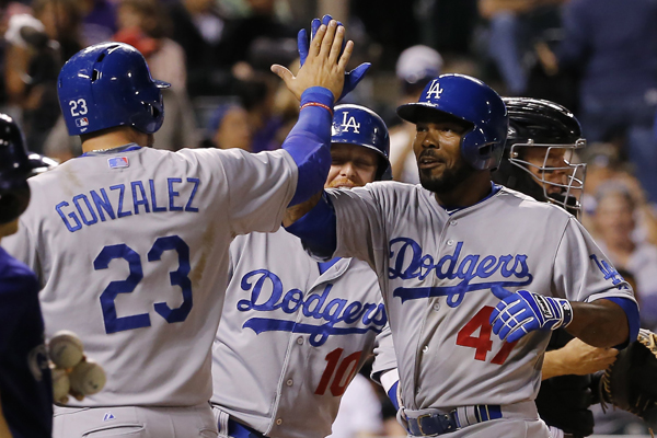 Dodgers second baseman Howie Kendrick, right, celebrates with teammate Adrian Gonzalez after hitting a three-run home run in the eighth inning of a win over the Colorado Rockies.