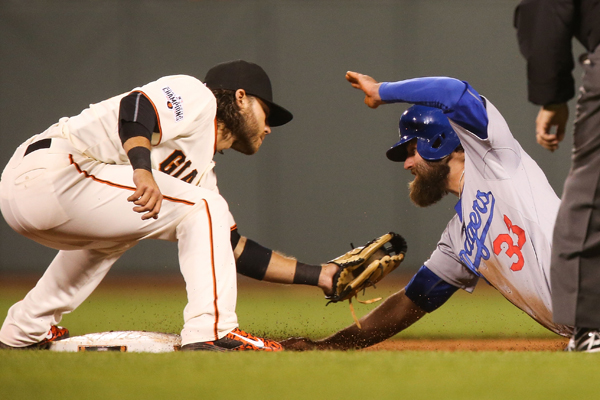 San Francisco Giants shortstop Brandon Crawford, left, tags out Dodgers baserunner Scott Van Slyke during the eighth inning of the Giants' win.