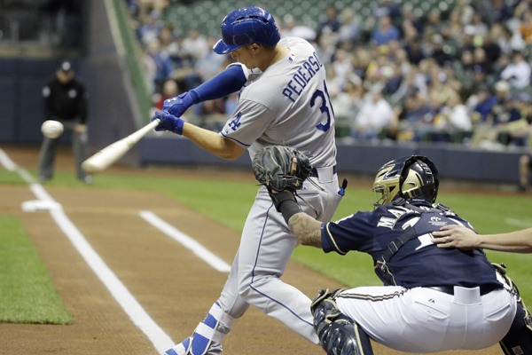 Dodgers center fielder Joc Pederson hits during the first inning of a loss to the Milwaukee Brewers.