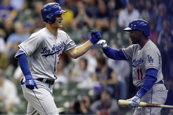 Dodgers center fielder Joc Pederson, left, celebrates with shortstop Jimmy Rollins after hitting a solo home run against the Milwaukee Brewers.