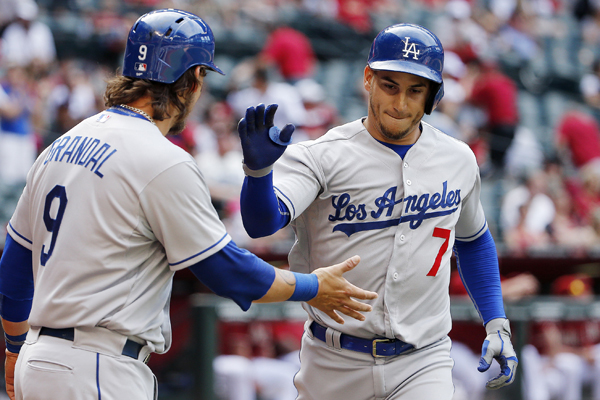 Dodgers third baseman Alex Guerrero, right, is congratulated by teammate Yasmani Grandal after hitting a two-run home run against the Diamondbacks.