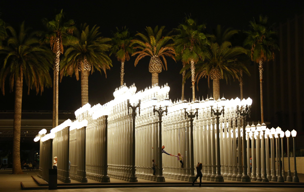 LACMA visitors explore the <a href="http://collections.lacma.org/node/214966" target="_blank">"Urban Light" sculpture by Chris Burden</a> on Oct. 20, 2012.