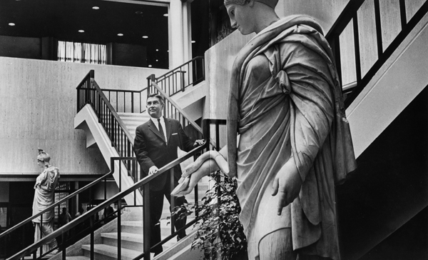 March 21, 1965. LACMA Director Richard F. Brown is photographed on a staircase in the atrium in the Ahmanson gallery before the museum's opening in 1965.