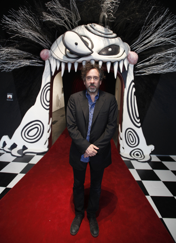 Tim Burton stands at the entrance to the LACMA exhibition devoted to his work as a filmmaker and illustrator.