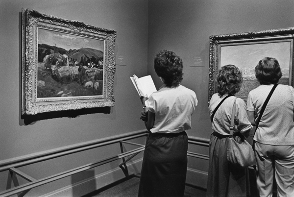 LACMA visitors view French impressionists' paintings on display in the "Day in the Country" exhibit.