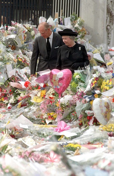 Queen Elizabeth II and her husband, Prince Philip, look at floral tributes left outside Buckingham Palace  on Sept. 5, 1997, following the death of Diana, Princess of Wales. 