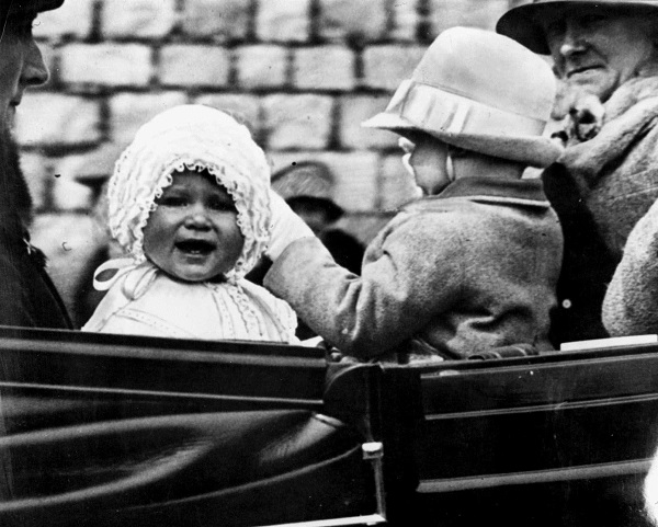 Princess Elizabeth, left, is taken for a ride on the grounds of Windsor Castle in 1927.