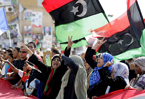 Libyans in rebel-held Benghazi celebrate after receiving news of an arrest warrant issued against Moammar Kadafi.