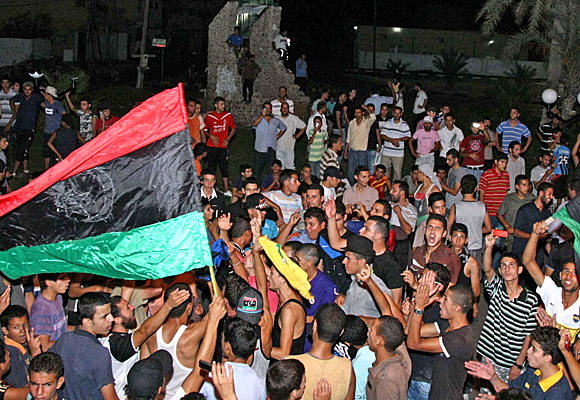 Thousands celebrate in Benghazi as rebel fighters push into Tripoli.