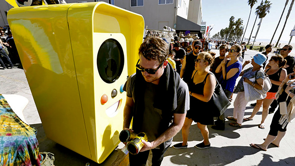 Snapchat Spectacles are dispensed from a bright yellow vending machine on the Venice Beach boardwalk. 