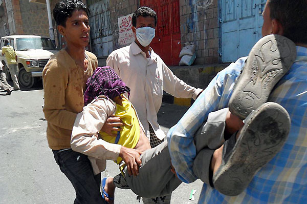 A Yemeni is carried away during clashes in the city of Taiz.