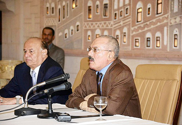 Yemeni President Ali Abdullah Saleh, right, delivers a speech on state TV in which he said he would step down soon. Vice President Abdu Rabu Mansour Hadi sits to Saleh's right..