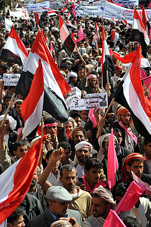 Protesters wave national flags during a protest in Yemen's capital, Sana.
